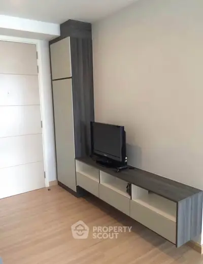 Modern living room with sleek TV unit and wooden flooring