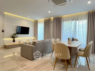 Elegant living room with modern decor, large windows, and stylish furniture in a luxurious home.