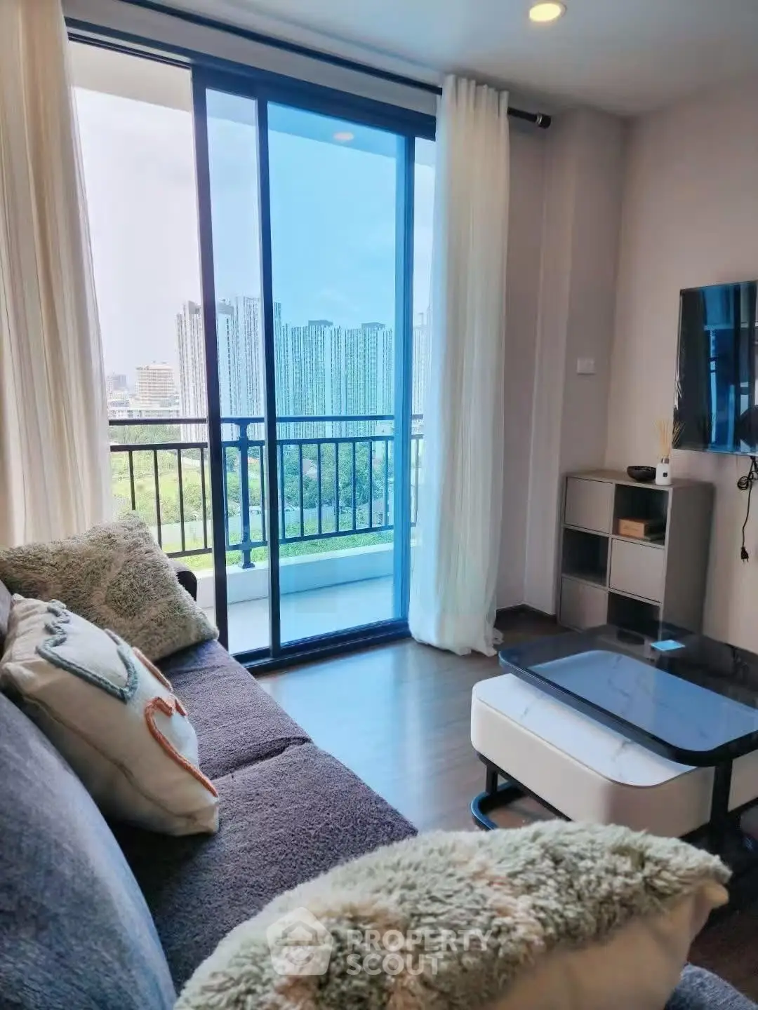 Modern living room with balcony view in high-rise apartment