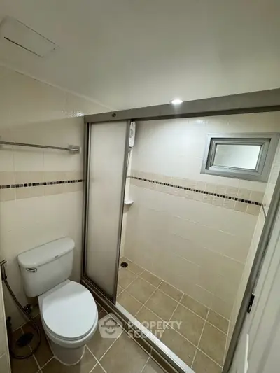 Modern bathroom with shower and toilet in neutral tones