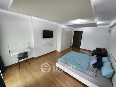 Spacious modern bedroom with minimalist design and wooden flooring