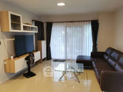 Modern living room with sleek furniture and large window for natural light