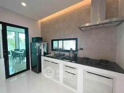 Modern kitchen with sleek design, featuring gas stove and ample storage, perfect for culinary enthusiasts.