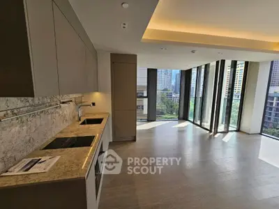 Modern kitchen with open layout and city view, featuring sleek cabinetry and built-in appliances.