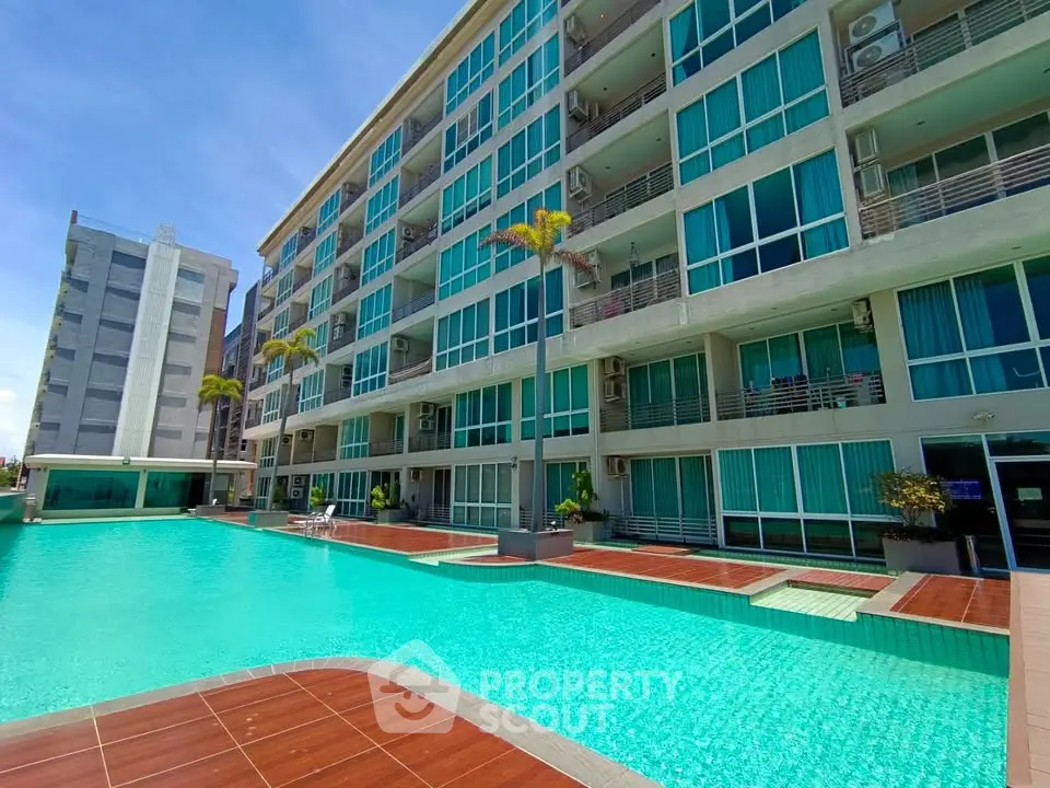 Luxurious apartment complex with stunning pool and modern architecture.