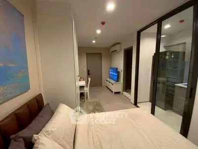 Modern studio apartment with cozy bedroom and open kitchen layout