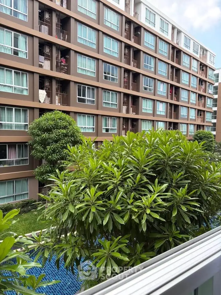Modern apartment building with lush greenery and spacious balconies
