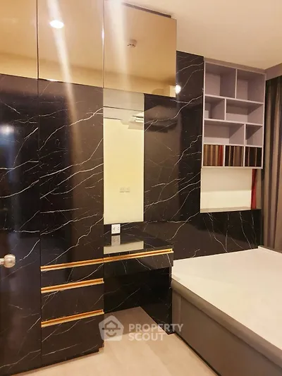 Luxurious bedroom with elegant black marble accents and modern shelving