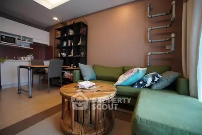 Stylish living room with unique industrial decor and cozy green sofa