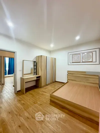 Spacious bedroom with modern wooden furniture and elegant decor