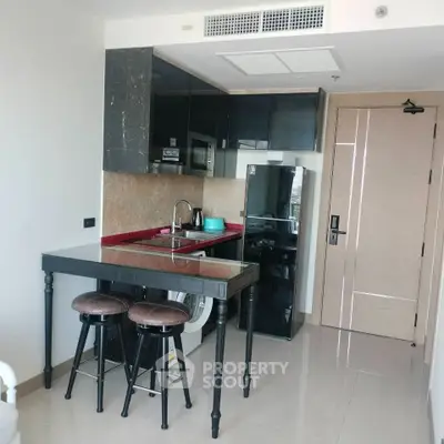 Modern compact kitchen with sleek design and integrated appliances in urban apartment.