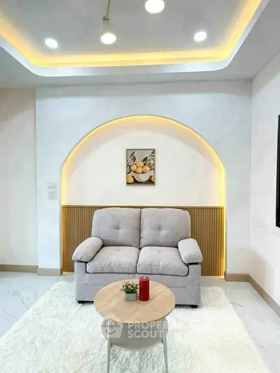 Modern living room with cozy sofa, stylish lighting, and elegant decor.