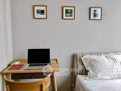 Cozy bedroom with study desk and stylish decor, perfect for modern living.