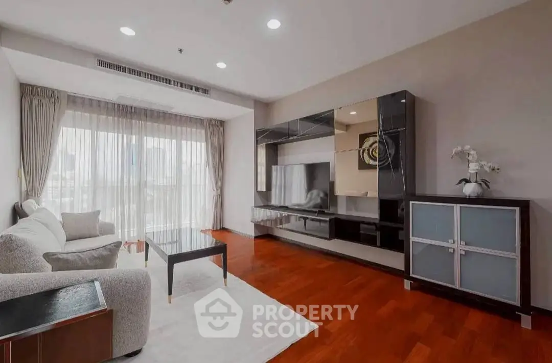 Spacious modern living room with elegant furniture and large window for natural light.