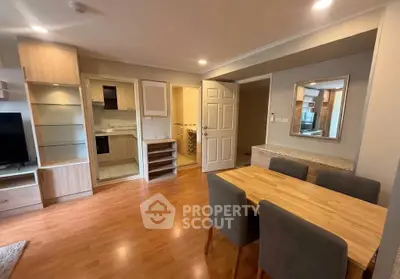 Spacious open-plan living room with modern dining area and wooden flooring.