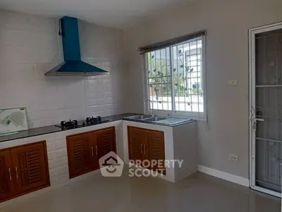 Modern kitchen with gas stove and sleek cabinetry in bright, airy space.