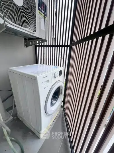 Modern balcony with washing machine and sleek vertical slat design