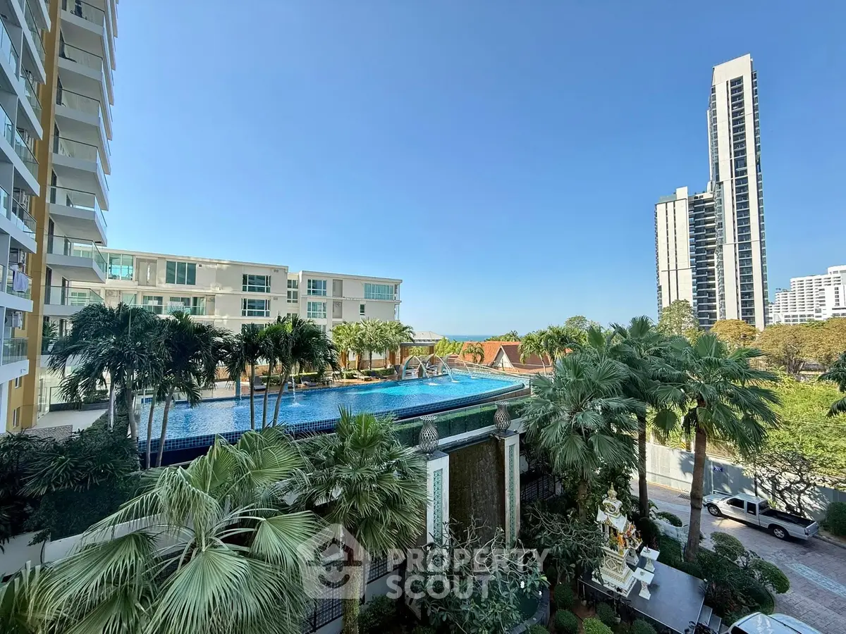 Luxurious residential complex with stunning pool and lush greenery