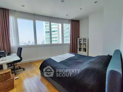 Spacious bedroom with city view and modern furnishings