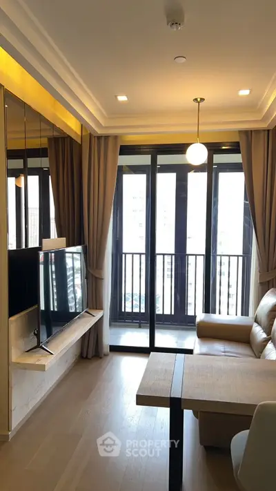 Modern living room with balcony view, featuring sleek TV setup and cozy seating area.