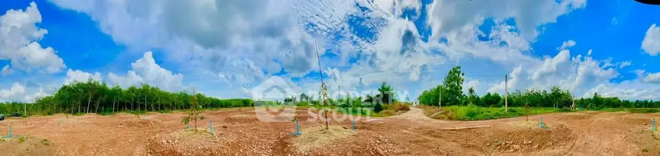 Expansive panoramic view of undeveloped land with clear blue skies, perfect for real estate investment.
