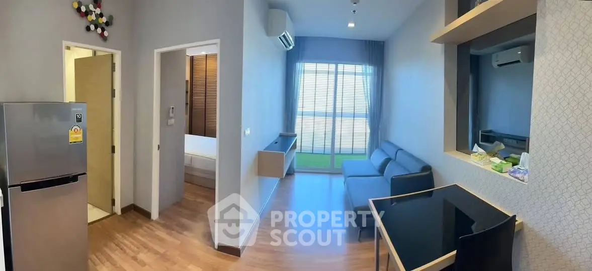 Modern living room with sleek furniture and large window for natural light