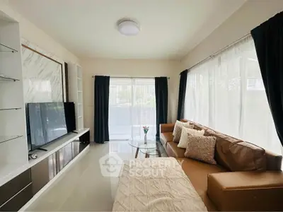 Spacious living room with modern decor and large windows for natural light
