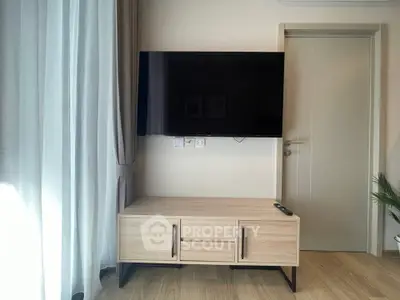 Modern living room with wall-mounted TV and stylish wooden cabinet