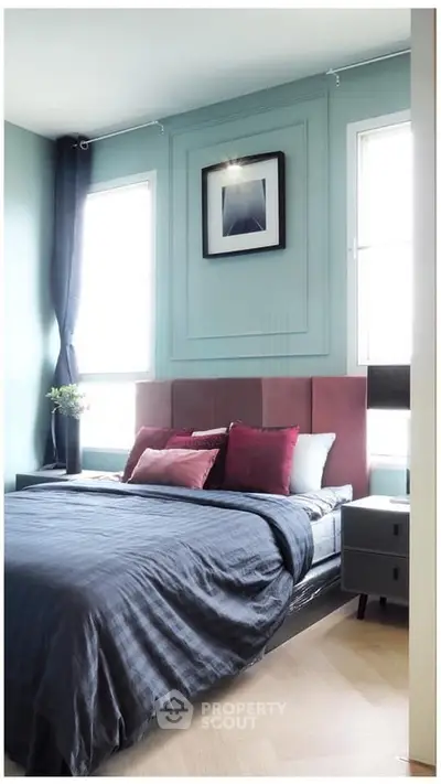 Stylish bedroom with modern decor and natural light, featuring a cozy bed and elegant wall art.