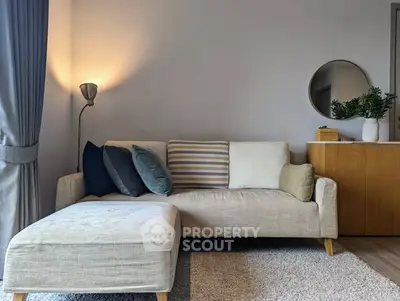 Modern living room with stylish sofa, cozy lighting, and elegant decor.