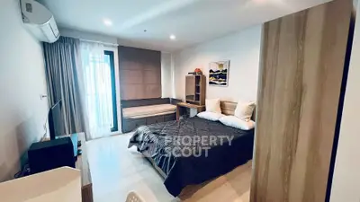 Modern bedroom with stylish decor and natural light in a contemporary apartment.
