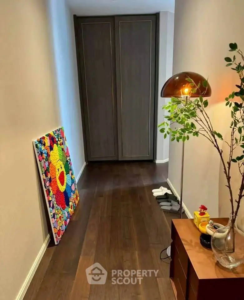 Stylish hallway with modern decor and vibrant artwork in a contemporary home.