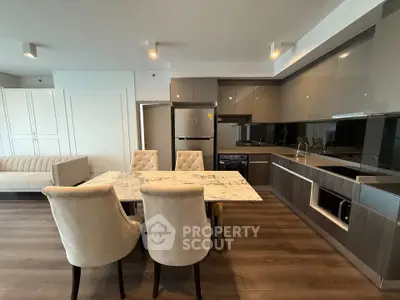 Modern kitchen with marble dining table and sleek cabinetry in open layout
