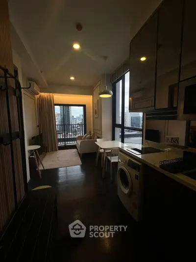 Modern apartment with open layout, featuring a cozy living area and city view balcony.