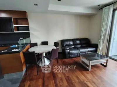 Modern living room with sleek furniture and open kitchen layout