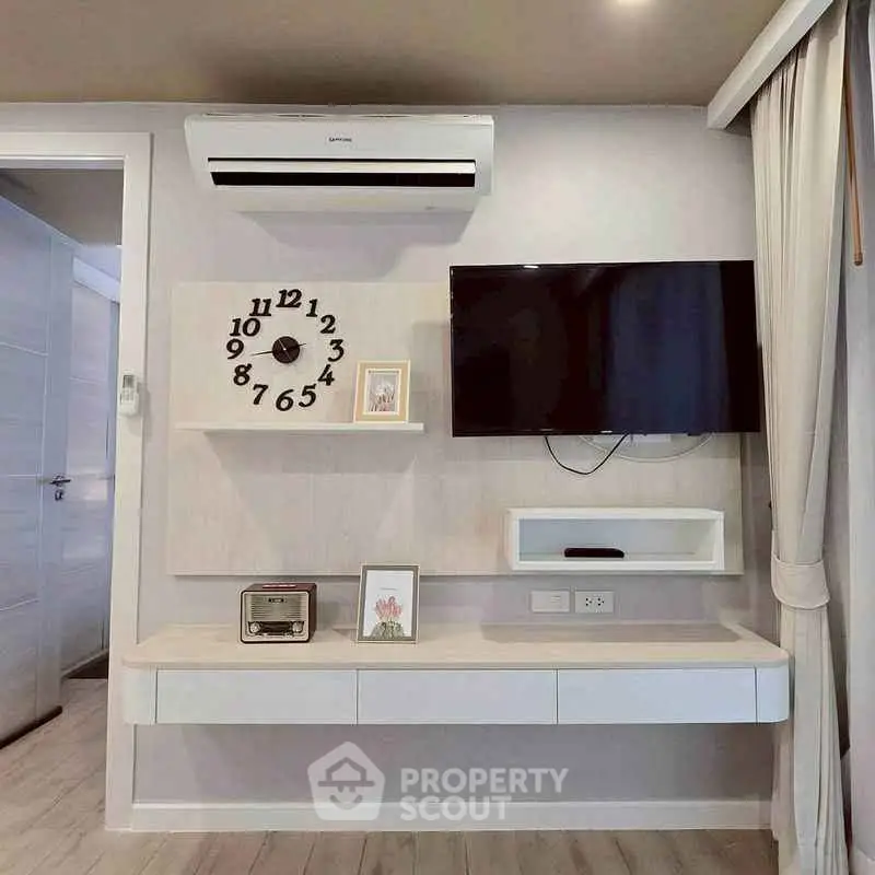 Modern living room with wall-mounted TV and stylish decor