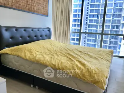 Modern bedroom with large window and city view, featuring a stylish bed and contemporary decor.