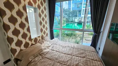 Cozy bedroom with large window overlooking pool and modern decor