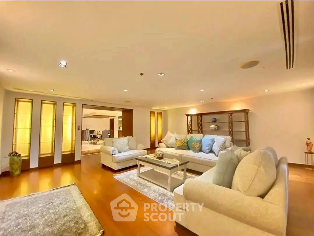 Spacious and inviting living room with elegant furniture and warm lighting.