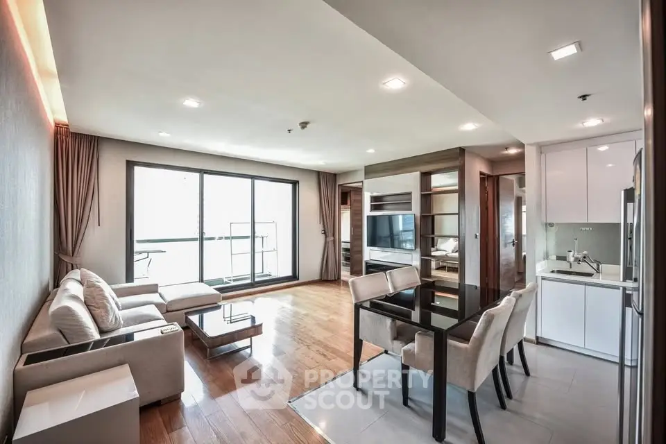 Spacious modern living room with open kitchen and large windows in luxury apartment