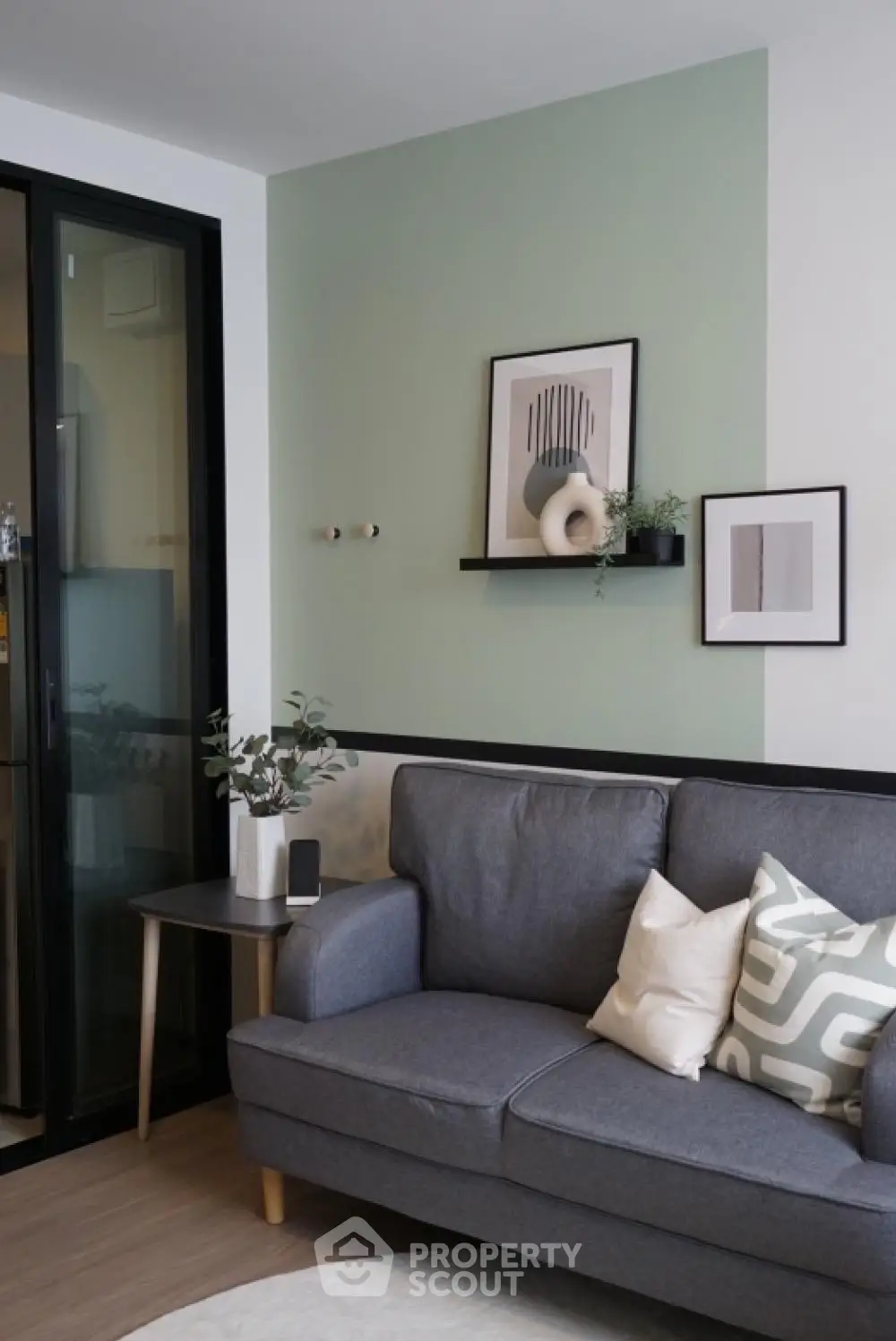 Modern living room with stylish decor and cozy gray sofa, perfect for relaxation.