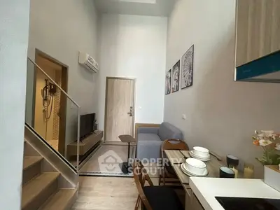 Modern compact living room with dining area and staircase in stylish apartment