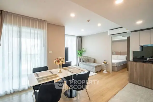 Modern open-plan living and dining area with stylish decor and natural light.