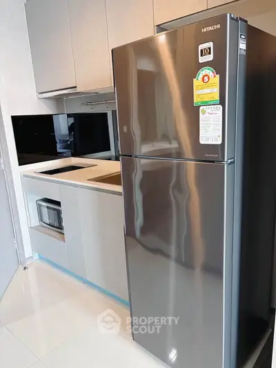 Modern kitchen with sleek stainless steel fridge and built-in appliances