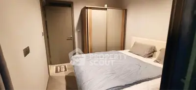 Cozy bedroom with modern decor and ample storage space in a stylish apartment.
