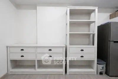 Modern storage area with white shelves and drawers in a minimalist design