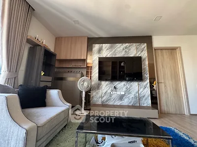 Modern living room with stylish decor and large TV setup