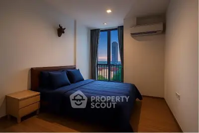 Modern bedroom with city view, featuring sleek design and cozy ambiance.