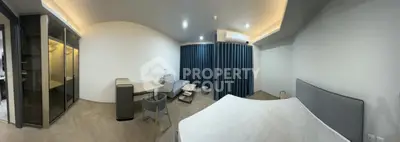 Spacious modern bedroom with stylish furniture and ambient lighting