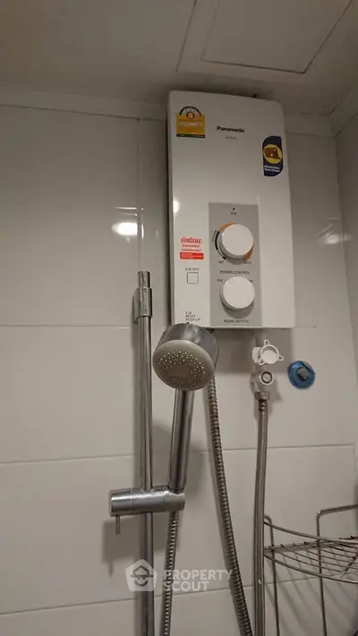 Modern bathroom with water heater and showerhead
